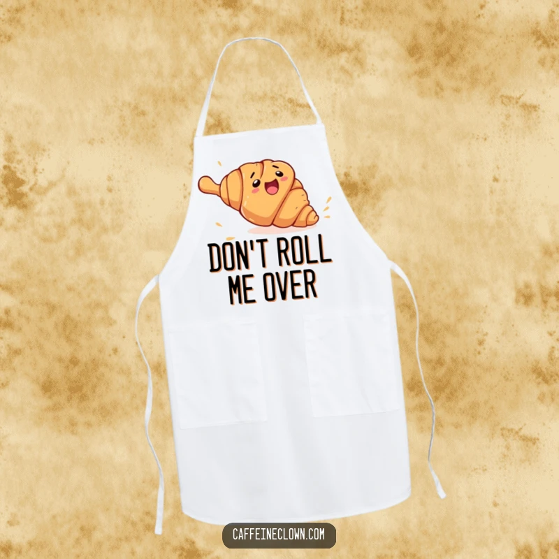 Funny croissant rolling apron showing a clumsy croissant character fleeing from a giant rolling pin, a comedic kitchen essential.
